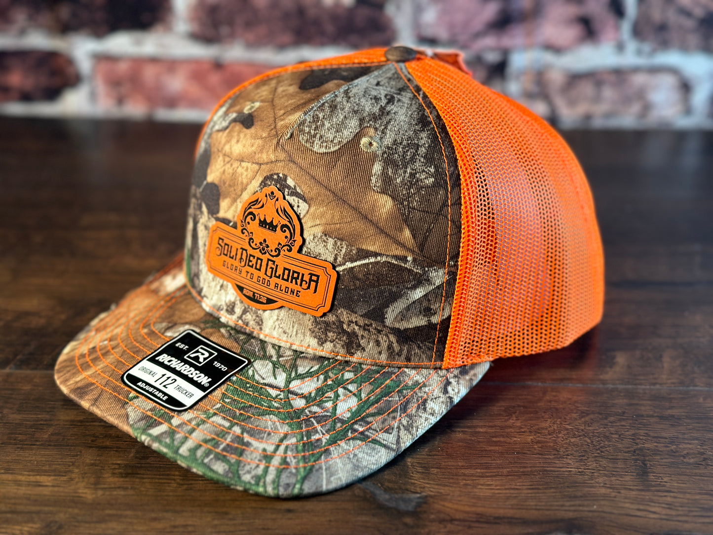 SDG Realtree Edge and Blaze Orange Trucker Hat with Orange Patch